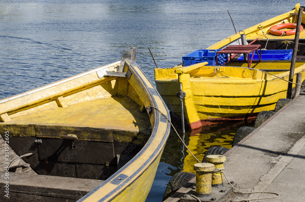 Naklejka premium A SMALL FISHING PORT - Traditional fishing boats moored at the quay