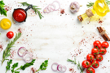 White wooden background of cooking. Spices and vegetables. Top view. Free space for your text.