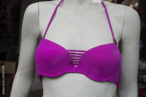 closeup of purple bikini on mannequin in fashion store showroom for women
