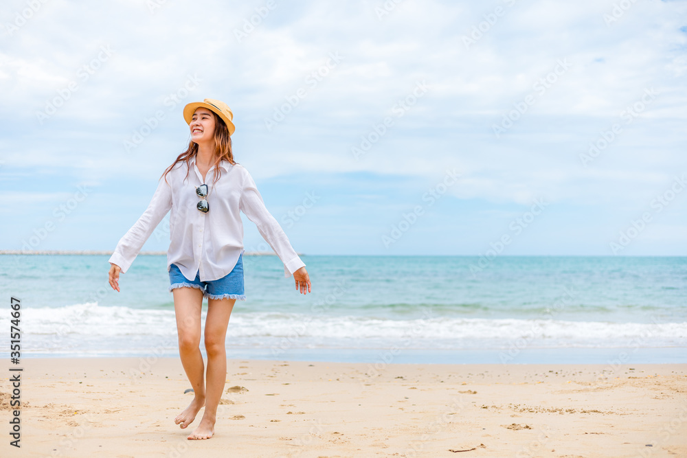 Happy young girl walking on the beach. Summer travel, vocation, holiday concept. Happy young girl walking on the beach. Summer travel, vocation, holiday concept.