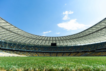 grassy football pitch at stadium at sunny day with blue sky