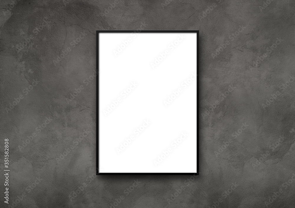 Black picture frame hanging on a dark concrete wall Black picture frame hanging on a dark concrete wall