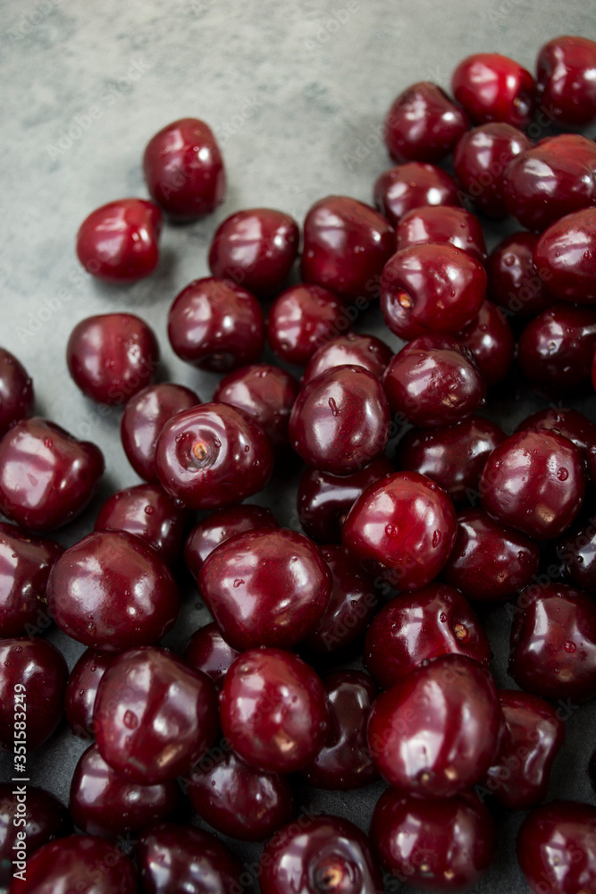 Sweet cherry ( black cherries) with water drops as background Sweet cherry ( black cherries) with water drops as background
