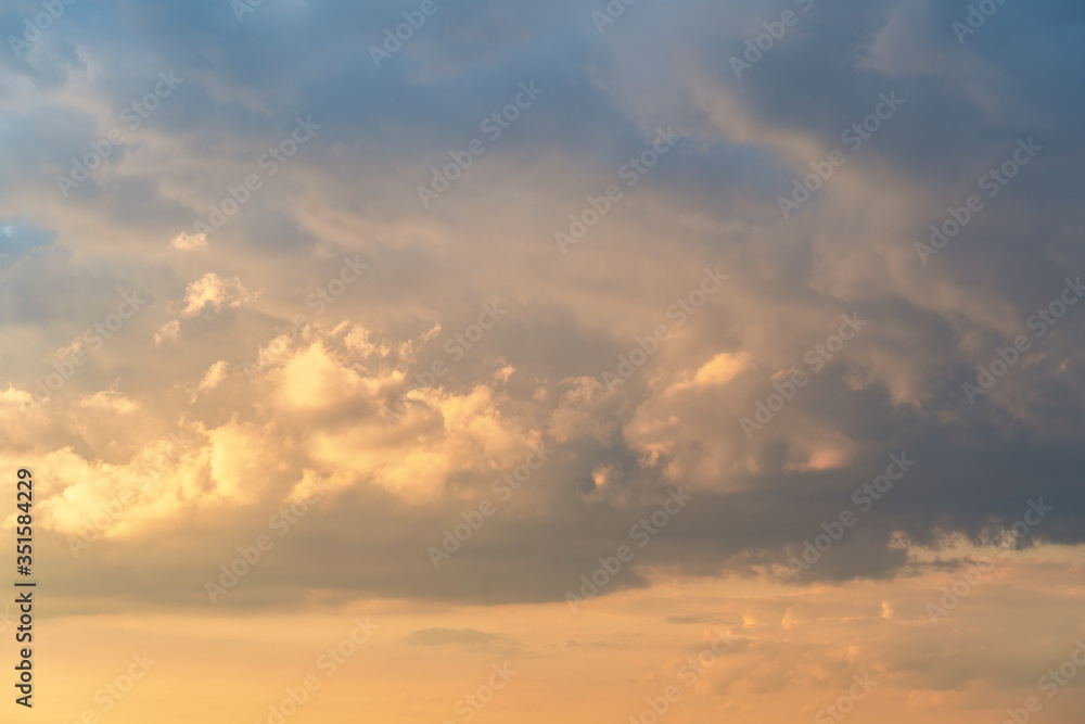 orange sunset sky with lighted clouds
