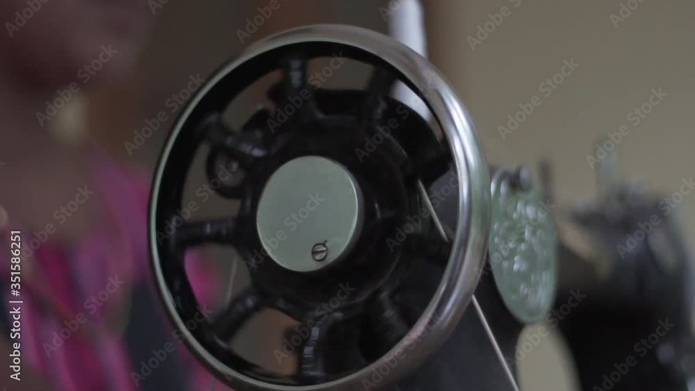 Close up of old sewing machine with women's hands on table slow motion Close up of old sewing machine with women's hands on table slow motion