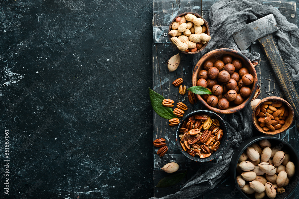 Set of nuts. Macadamia nuts, pecans, peanuts and almonds. Top view. Set of nuts. Macadamia nuts, pecans, peanuts and almonds. Top view.