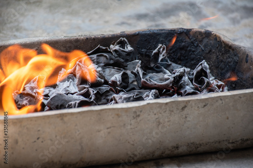 Remain of paper boncamp that Chinese burn it for show the respect to their ancestors on Qingming day.