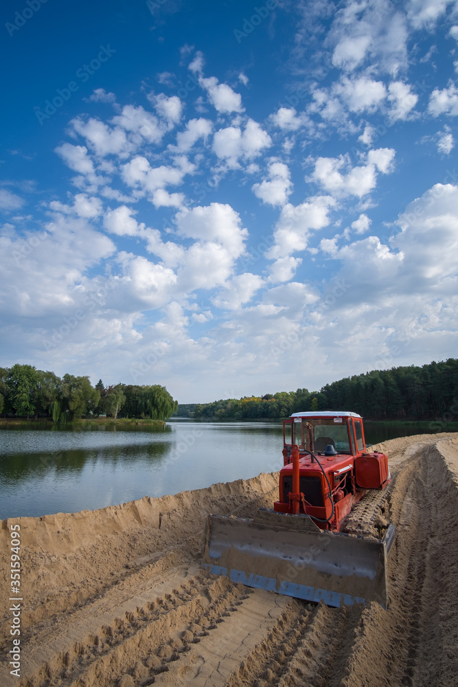 Fototapeta premium tractor on the dam construction