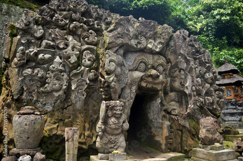 Ancient sculpture carving gate entrance tunnel of Goa Gajah or Elephant Cave significant Hindu archaeological site for travelers people travel visit and respect praying at Ubud city in Bali, Indonesia © tuayai