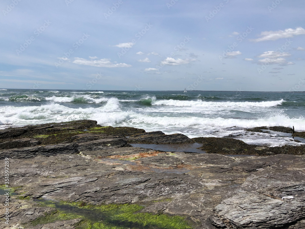 Rocky shoreline with churning waves and tide pools