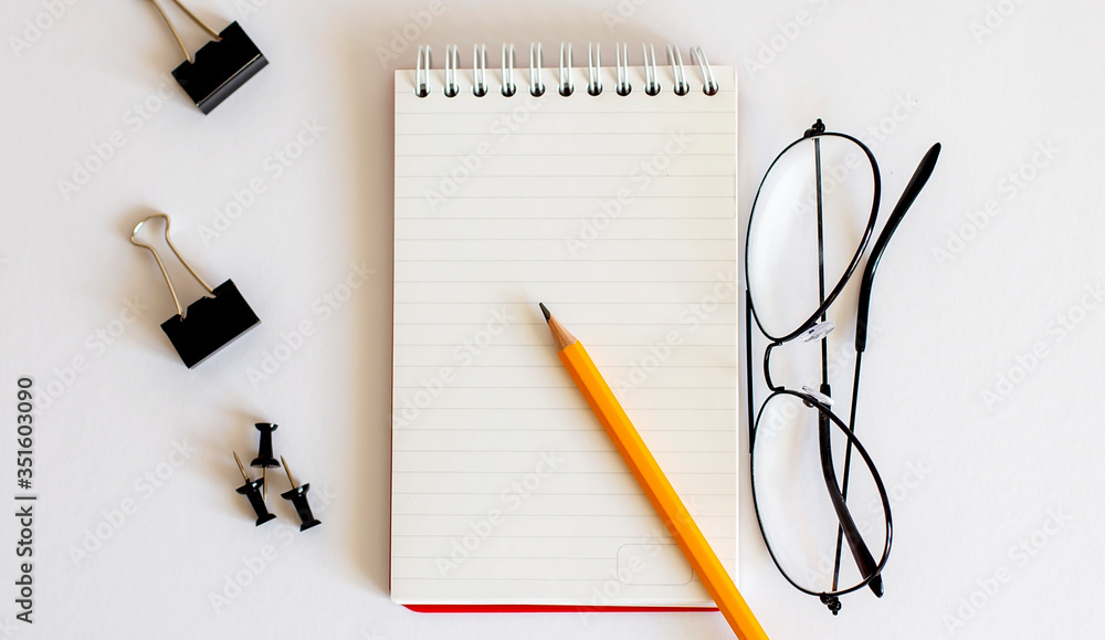 blank notebook with glasses and pencil on wooden table, business concept blank notebook with glasses and pencil on wooden table, business concept