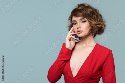 portrait of a woman on a blue background in a red dress. Retro style. Lady with an open neckline. Copycpase