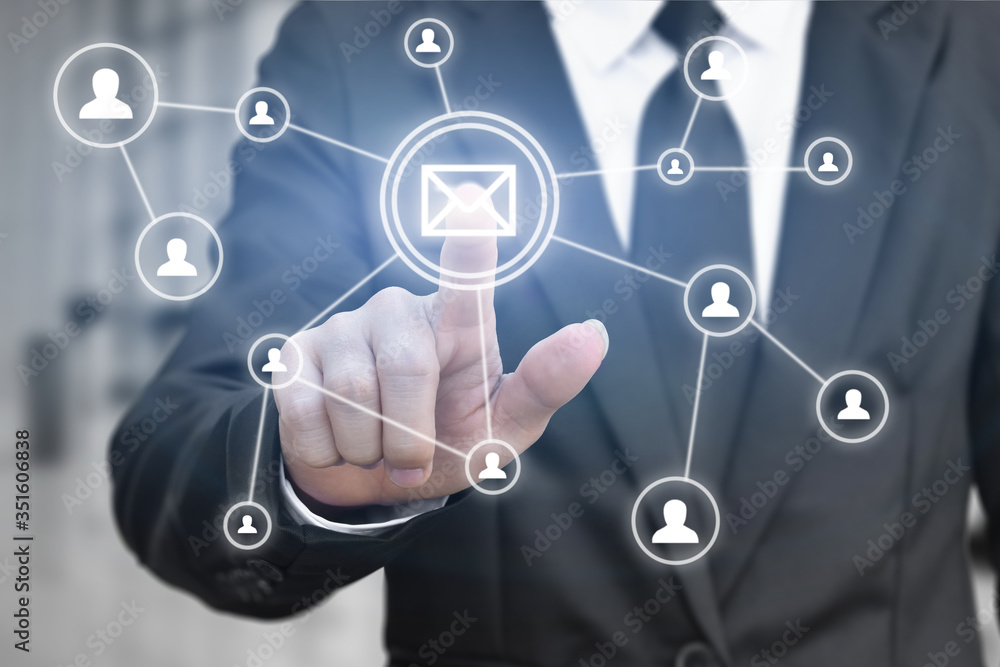 Businessman hand press email button icon on virtual screen for network connection. Idea for contact communication in business. Businessman hand press email button icon on virtual screen for network connection. Idea for contact communication in business.