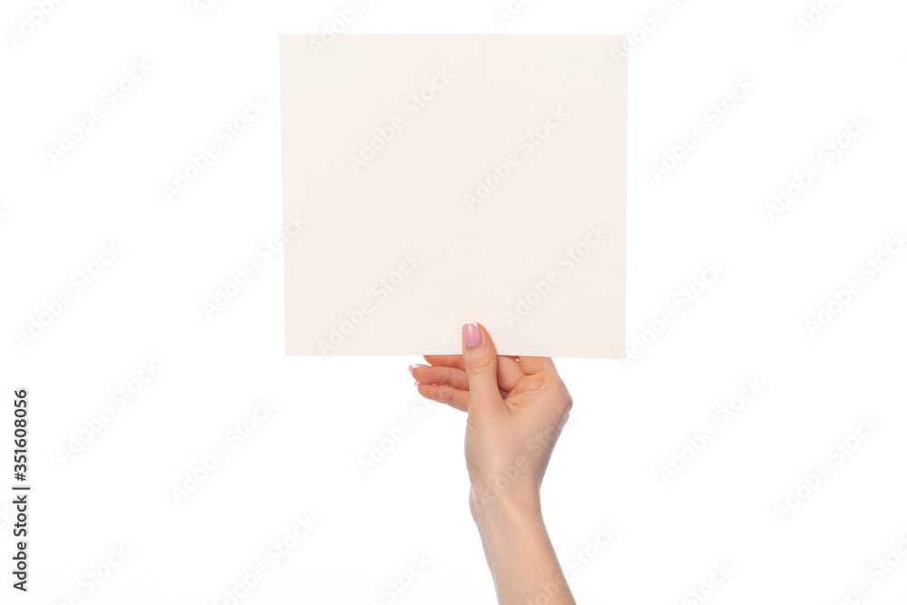 Woman's hand showing white paper banner isolated on white Woman's hand showing white paper banner isolated on white
