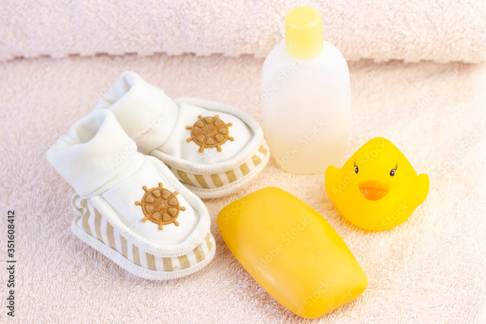 baby hygiene and bath items, shampoo bottle, baby soap, towel, yellow duck rubber toy, cotton pads and ear sticks, comb. baby hygiene and bath items, shampoo bottle, baby soap, towel, yellow duck rubber toy, cotton pads and ear sticks, comb.