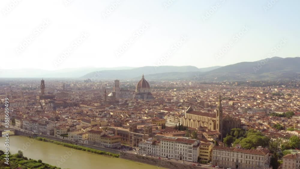 Aerial view of historic landmarks with river in city against sky, drone over cityscape on sunny day - Florence, Italy Aerial view of historic landmarks with river in city against sky, drone over cityscape on sunny day - Florence, Italy