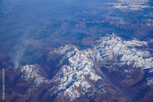 Landscape with mountains. Top view. Blue wallpaper. Shot from airplane.