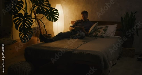 Man switching lighting on and off with home hub