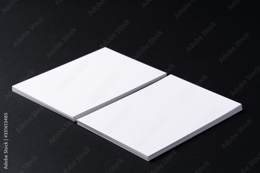 White blank business cards on dark black background White blank business cards on dark black background