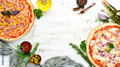 Pizza background on white wooden table. Top view. free space for your text. Rustic style.