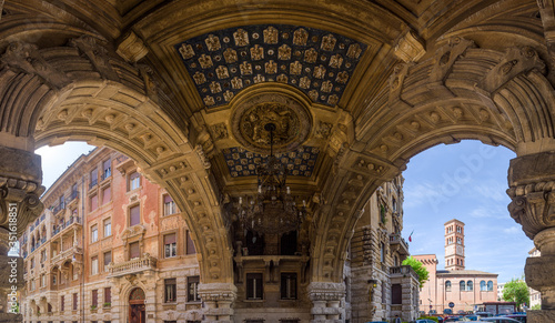 Panoramic composite of arch gallery ceiling  with stone carvings and painted patterns in Quartiere Copped    a 20th century Liberty Style architecture district in Rome  Italy