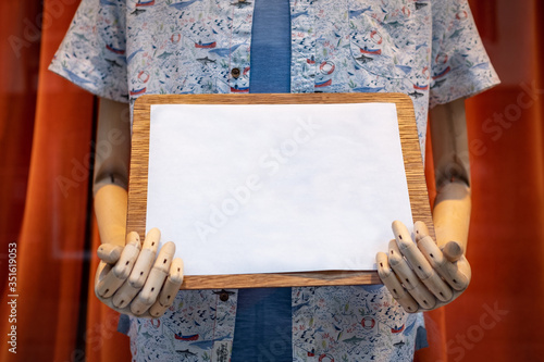 Hands holding blank clipboard