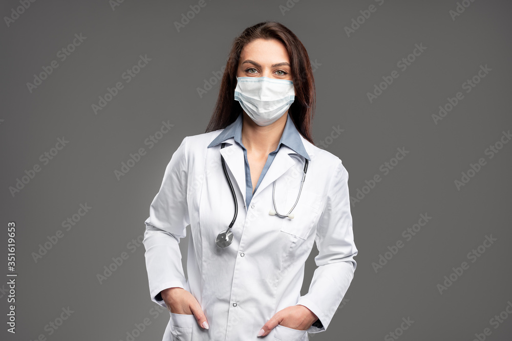 Female doctor with hands in pockets Female doctor with hands in pockets