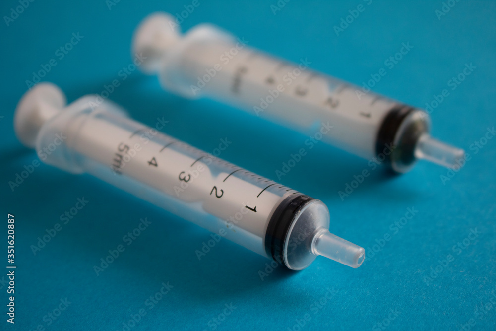 Syringes on blue paper, for people injection Syringes on blue paper, for people injection