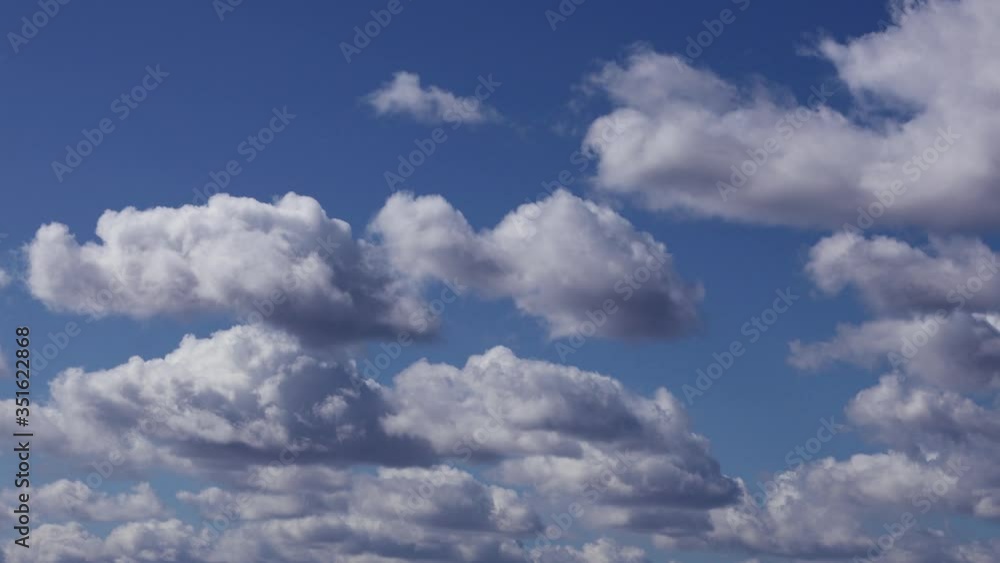 White clouds move slowly against the blue sky White clouds move slowly against the blue sky