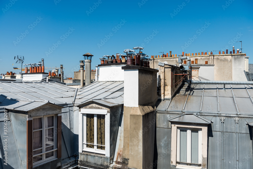 Rooftops of the houses in Paris with Chimneys.