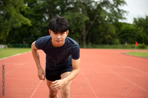 Young Asian Athletic man running in track to practice himself