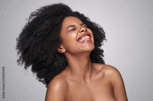 Pretty black woman laughing at joke