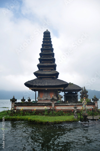 Meru towers of Pura Ulun Danu Bratan or Pura Bratan Hindu Shaivite Shiva temple archaeological site for travelers people travel visit and respect praying in Lake Bratan near Bedugul in Bali, Indonesia