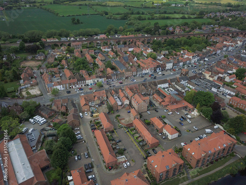 The historic market town of Yarm in North Yorkshire from above by drone showing the River Tees
