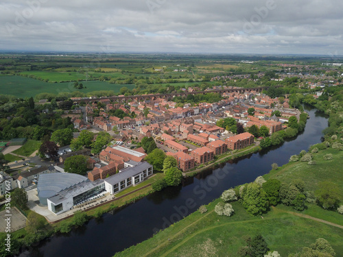 The historic market town of Yarm in North Yorkshire from above by drone showing the River Tees 