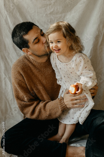 Father kissing a happy child on the cheek
