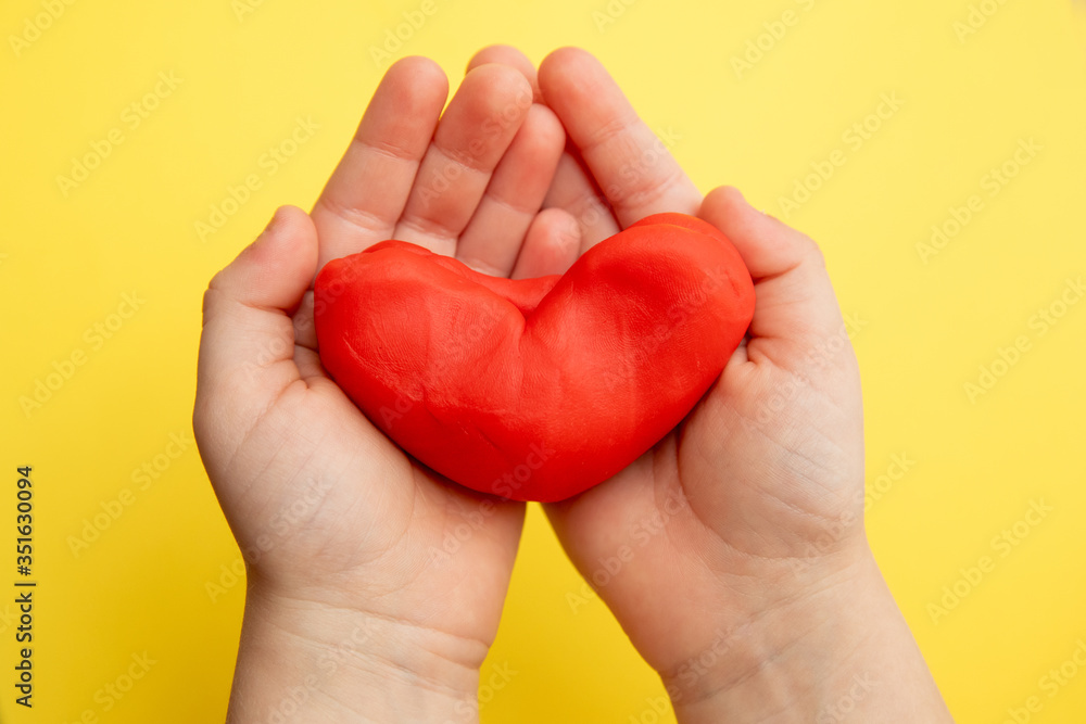 Obraz premium Red plasticine in children's hands