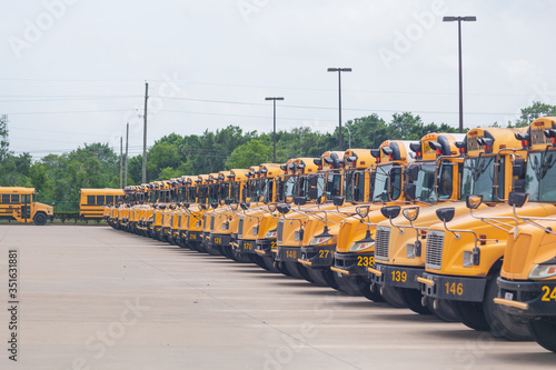 Idle school buses await the reopening of K-12 schools