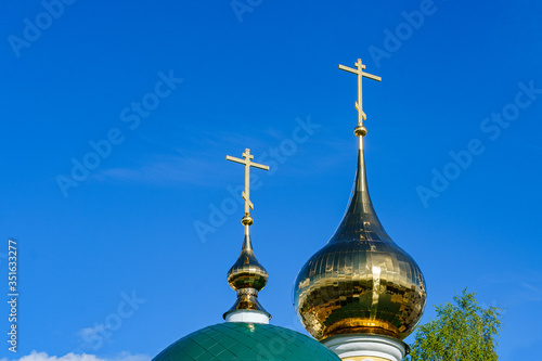 domes of an orthodox temple made of golden metal