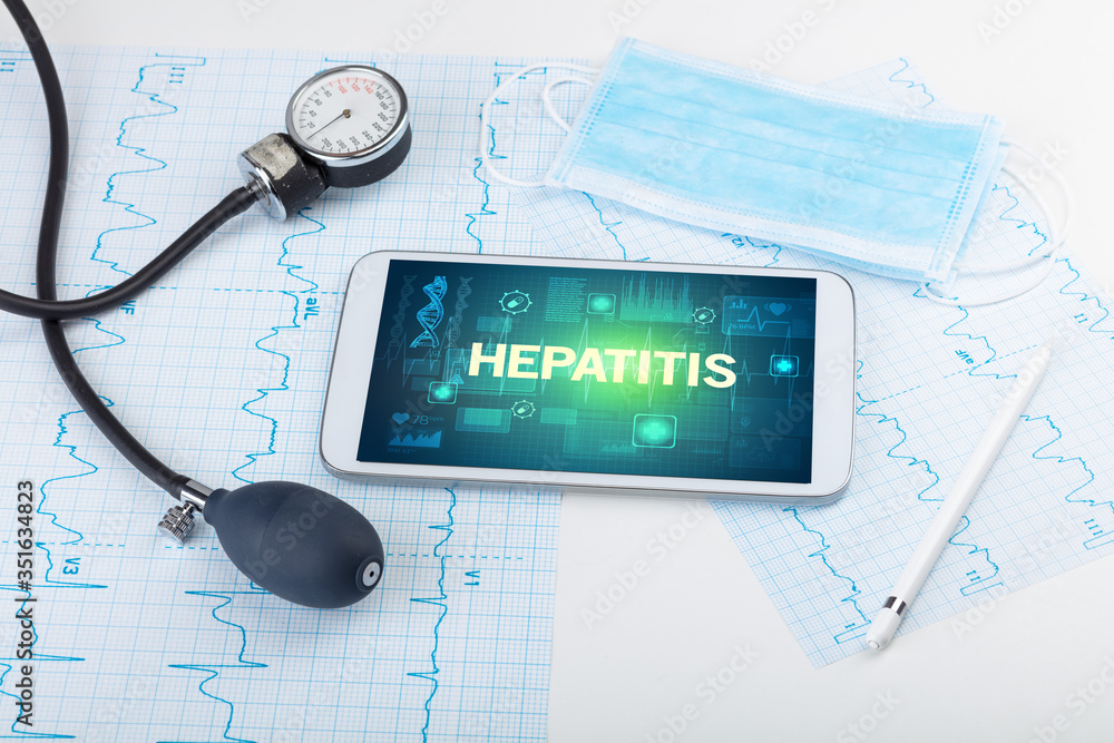 Tablet pc and medical stuff with HEPATITIS inscription, prevention concept Tablet pc and medical stuff with HEPATITIS inscription, prevention concept