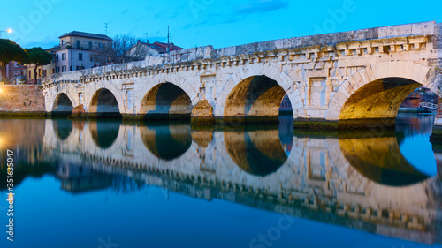 Bridge of Tiberius in Rimini and its reflection photo