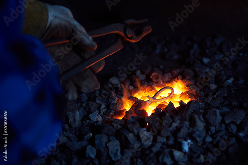 The process of forging hot steel in the forge 1