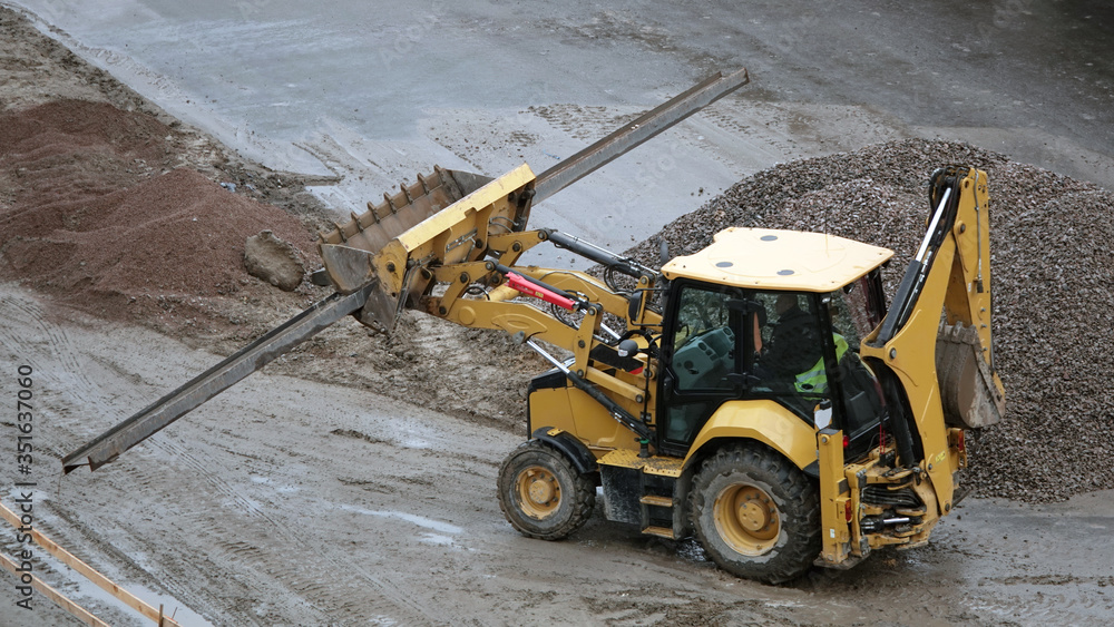Tractors and excavators work on the construction of the foundation zero cycle Tractors and excavators work on the construction of the foundation zero cycle