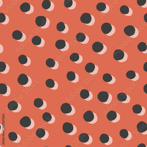 Vector seamless pattern with offset polka dots. Orange and black trendy spots great for fabric and wrapping paper.