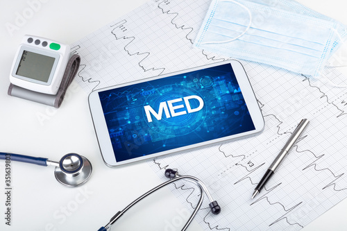 Close-up view of a tablet pc with MED abbreviation, medical concept