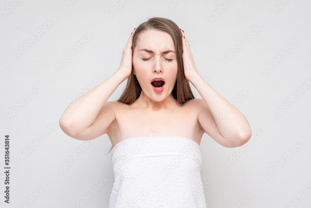 Capricious girl screaming and covers her ears, ignore the unpleasant sound, white background, copy space Capricious girl screaming and covers her ears, ignore the unpleasant sound, white background, copy space