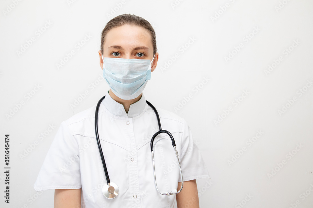 Young woman doctor with stethoscope and mask Young woman doctor with stethoscope and mask