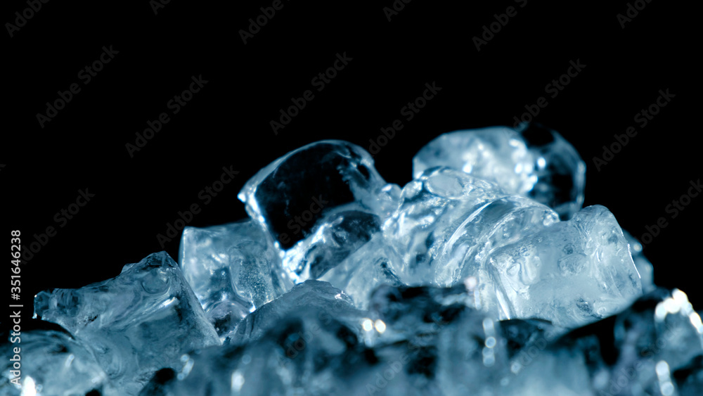 Top view of ice rotation on black background. Close up. Top view of ice rotation on black background. Close up.