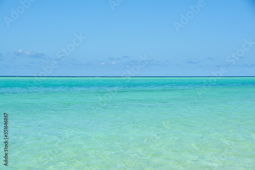 Turquoise water and blue sky. Maldives. Tropical beach with turquoise water. For wallpaper design.
