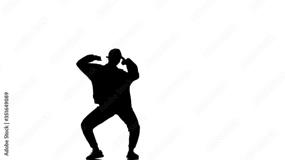 black silhouette on a white background, young beautiful girl dancer in tracksuit and baseball cap dancing hip hop, contemporary, modern street dance, slow motion black silhouette on a white background, young beautiful girl dancer in tracksuit and baseball cap dancing hip hop, contemporary, modern street dance, slow motion